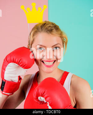 Fight for success. VIP gym. Fighting queen. Woman boxing glove and crown symbol of princess. Queen of sport. Become best in boxing sport. Feminine tender blonde with queen crown wear boxing gloves. Stock Photo