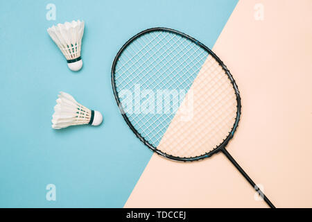 Shuttlecock and racket for playing badminton on a pástel color background. Minimalism. Concept summer razlecheny Stock Photo