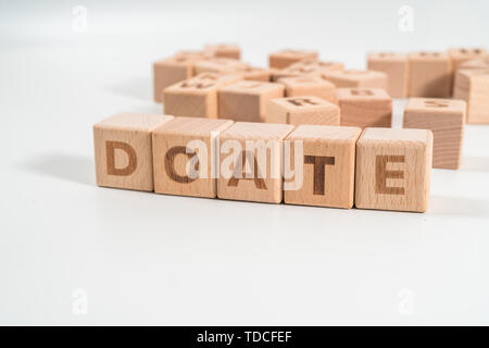Donate wooden blocks of business concept isolated on white background. Stock Photo