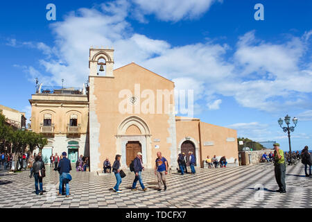 Taormina, Sicily, Italy - Apr 8th 2019: People on the main square in historical old town. Piazza IX Aprile square is a popular tourist attraction. Amazing Italian city. Tourists sightseeing. Stock Photo