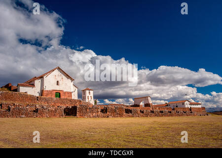 View on the small rustic town of Chinchero in Sacred Valley near the Cusco city in Peru. Incan ruins and colonial church with characteristic arches. Stock Photo