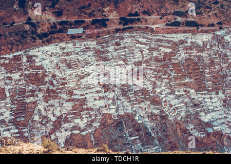 Aerial view on the salt mines in Maras valley near the Cusco city in Peru. Salt evaporation ponds. Tourist destination in Sacred Valley. Stock Photo