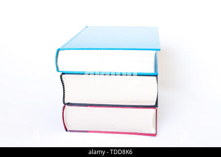 Stack of thick hardcover books isolated on white background. Stock Photo