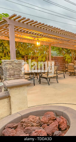 Stone Benches Around A Fire Pit Outside A Residential Building On