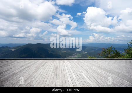 Empty brick floor with green hills Stock Photo