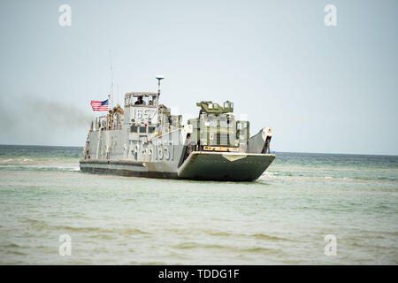 190612-N-MD802-1266 KALLASTE BEACH, Estonia (June 12, 2019) U.S. Marines with 22nd Marine Expeditionary Unit, U.S Navy Sailors assigned to USS Fort McHenry (LSD 43), Romanian Marines with 307 Regiment, and Spanish Marines, assigned to 2º Batallon De Desembarco, Brigada De Infanteria De Marina (2nd Landing Battalion, Marine Infantry Brigade) secure a beach after disembarking from the Lubin-class mine layer/landing ship ORP Gnierzno using Soviet Tracked Amphibious Transport (PTSM) and two Landing Craft Utility (LCU) ships using Lighter Amphibious Resupply Cargo Vehicles (LARC-V) and Medium Tacti Stock Photo