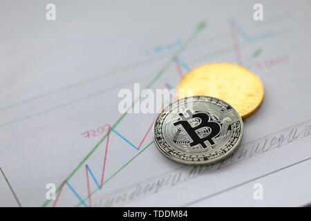 Silver and golden coin of bitcoin lie on business Stock Photo