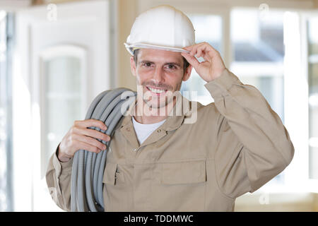 close up of electrician fitting wiring on construction site Stock Photo