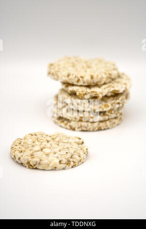Grain crispbreads on white background. Puffed whole grain crispbread. Dieting Eating Concept. Copy space Stock Photo