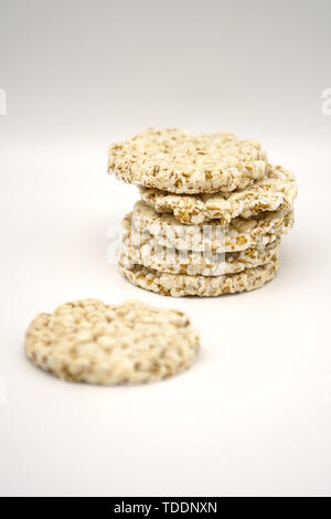 Grain crispbreads on white background. Puffed whole grain crispbread. Dieting Eating Concept. Copy space Stock Photo