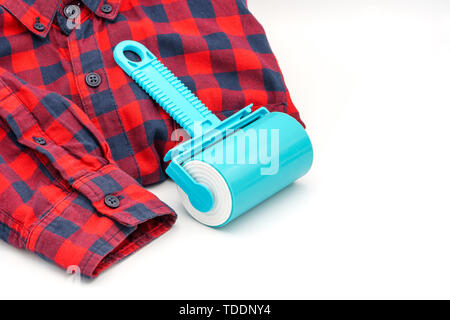 Sticky washable roller for cleaning clothes from animal hair and the pellet. Cleaning clothes and furniture from dust, wool, hair Stock Photo