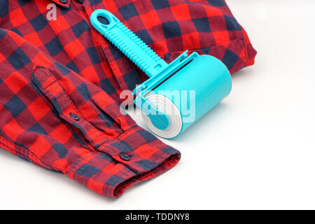 Sticky washable roller for cleaning clothes from animal hair and the pellet. Cleaning clothes and furniture from dust, wool, hair Stock Photo