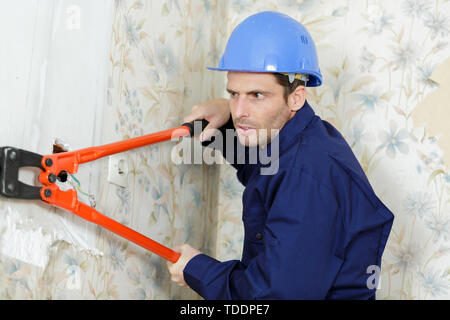 male builder using bolt croppers Stock Photo