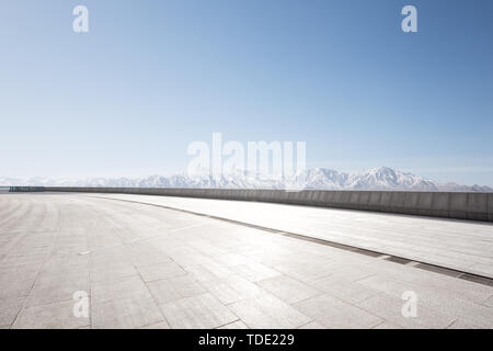 Empty floor with white snow mountains Stock Photo
