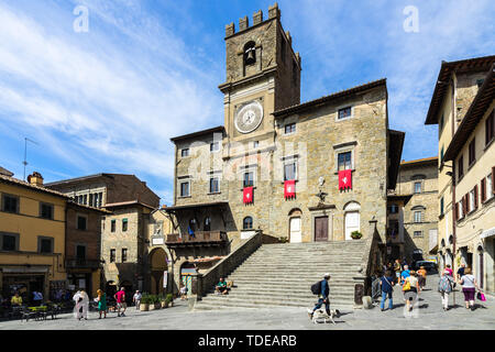 The main square of Cortona historic center dominated by town hall building (Palazzo Comunale) built in 16th century. Cortona, Italy, September 2018 Stock Photo