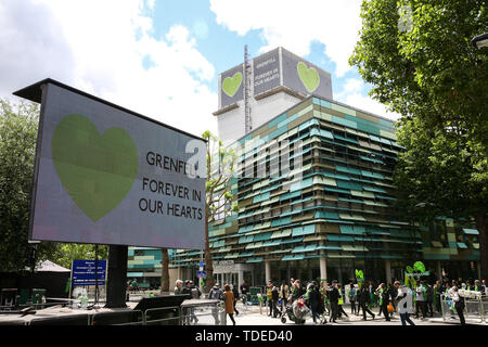 London, UK. 14th June, 2019. The Grenfell Tower during the commemoration. The Grenfell Tower second anniversary commemoration of the tower block fire. On 14 June 2017, just before 1:00am a fire broke out in the kitchen of the fourth floor flat at the 24-storey residential tower block in North Kensington, West London, which took the lives of 72 people. More than 70 others were injured and 223 people escaped. Credit: SOPA Images Limited/Alamy Live News Stock Photo