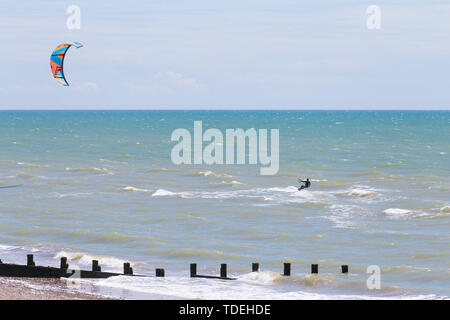Camber, East Sussex, UK. 15th June, 2019. UK Weather: A beautiful sunny start to the weekend in Camber, East Sussex as people arrive to the Camber Sands beach to enjoy the warm weather. A solitary kite surfer takes to the sea on a warm and pleasant day with a slight breeze in the air. Credit: Paul Lawrenson 2019, Photo Credit: Paul Lawrenson/ Alamy Live News Stock Photo