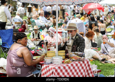 New York, USA. 15th June, 2019. Participants have a picnic during the 14th annual Jazz Age Lawn Party on Governors Island of New York, the United States, on June 15, 2019. The event which kicked off on Saturday this year, started in 2005 as a small gathering on Governors Island and has since grown into one of New York's most popular events. Thousands of visitors come to the event each year to discover the music and zeitgeist of the 1920s. Credit: Wang Ying/Xinhua/Alamy Live News Stock Photo