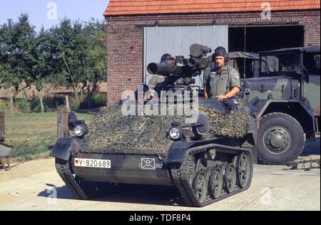 German paratroopers light tank Wiesel with a Belgian motorcyclist ...