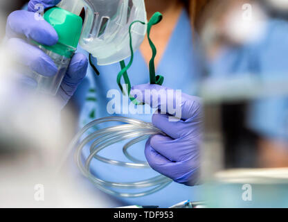 Nurse prepares oxygen mask in hospital, conceptual image Stock Photo