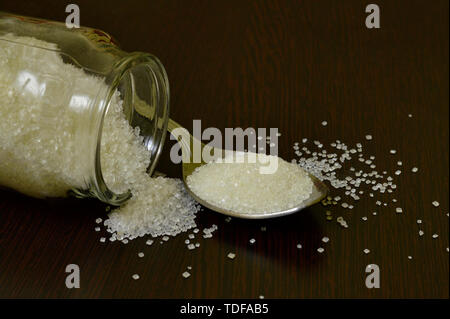 Spoon and sugar on table. Stock Photo