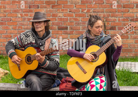 Male and female playing acoustic guitars Stock Photo