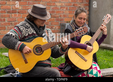 Male and female playing acoustic guitars Stock Photo