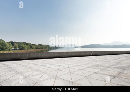 empty marble floor with beautiful lake in blue sky Stock Photo