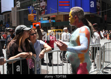 June 15, 2019 - New York, New York, U.S. - New York, NY Human Rights Connection Arts body painted over 100 models in N.Y.C's Times Square as part of their protest against Divisiveness after the models were painted they marched down Broadway to The FlatIron Building on 23rd Street and formed a song circle to finish the days protest. (Credit Image: © Bruce Cotler/Globe Photos via ZUMA Wire) Stock Photo