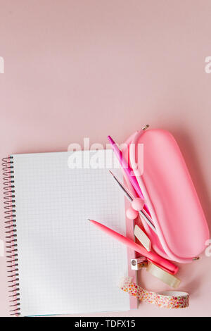 Back to school. Notebook, pencil case with pen and pencils on pink background. Stock Photo