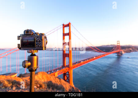 Camera with gold gate bridge over water Stock Photo