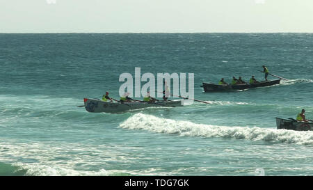 ALEXANDRA HEADLAND, QUEENSLAND, AUSTRALIA- APRIL 21, 2016: wide angle view of several surf boats finishing a race at alexandra headland on the sunshin Stock Photo