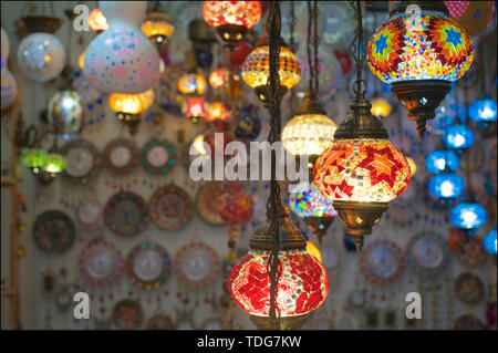 Close up picture of some illuminated arabic mosaic lanterns hanging from a ceiling of a market stall at Central Market in Kuala Lumpur, Malaysia Stock Photo