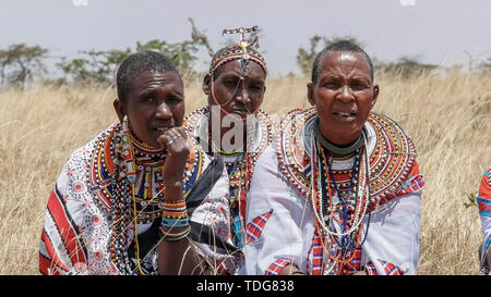 MASAI MARA, KENYA- 26, AUGUST, 2016: close up of three maasai women in traditional dress at koiyaki guiding school graduation day in kenya Stock Photo