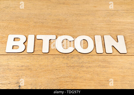Word - bitcoin, laid out in wooden letters on an old wooden table Stock Photo