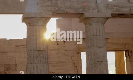 sun setting behind the propylaea at the acropolis in athens, greece Stock Photo