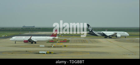 Shanghai, China - Jun 6, 2019. Juneyao Airbus A321 vs. Air New Zealand Boeing 787-9 taxiing on runway of Shanghai Pudong Airport (PVG). Stock Photo