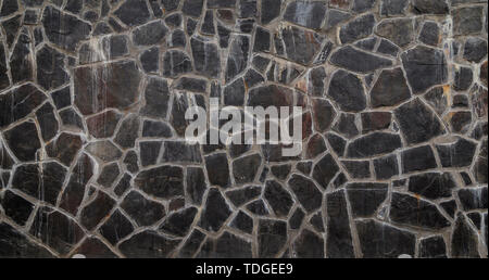 High resolution full frame background of an old, weathered and dirty stone wall with slates. Vignette and copy space. Stock Photo