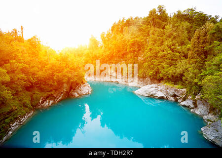 landscape of tranquil lake in green forest with sunlight Stock Photo