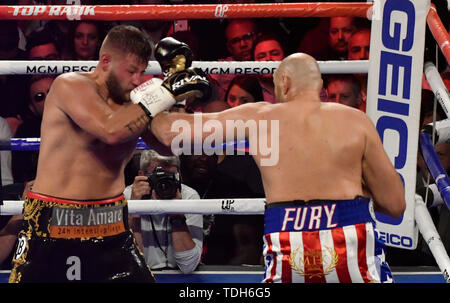 Las Vegas, USA. 15th June, 2019. UK Boxer Tyson Fury(R) hits Tom Schwarz during their fight at the MGM Grand Garden Arena on June 15, 2019 in Las Vegas, Nevada. Tyson Fury took the win by took the win by TKO after the fight was stop in the second round. Credit: ZUMA Press, Inc./Alamy Live News Stock Photo