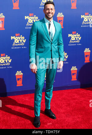 Actor Levi wearing a Paul Smith suit, Anto shirt, Christian Louboutin shoes, and a Montblanc