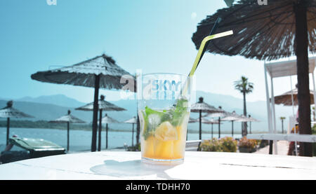 Montenegro 12.06.2019 Beach, mojito cocktail on the background of umbrellas. Stock Photo