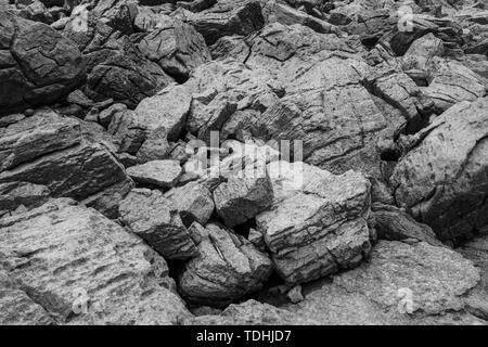 A black and white image of large boulders ideal for backgrounds and or textures, nobody in the image Stock Photo