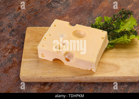 Maasdam cheese brick with thyme branch Stock Photo