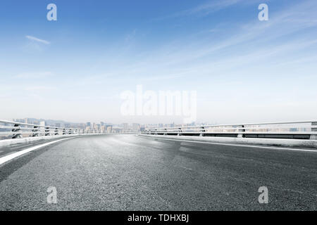 empty asphalt road with modern cityscape in foggy day Stock Photo