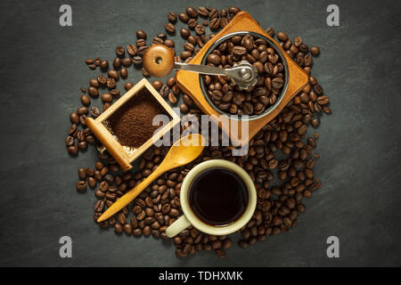 Coffee cup and coffee equipment on black cement floor. Top view and copy space for text. Stock Photo