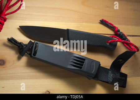 survival knife with a red paracord on the handle Stock Photo