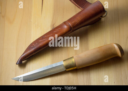 Knife handmade with a wooden handle knife in leather brown scabbard Stock Photo