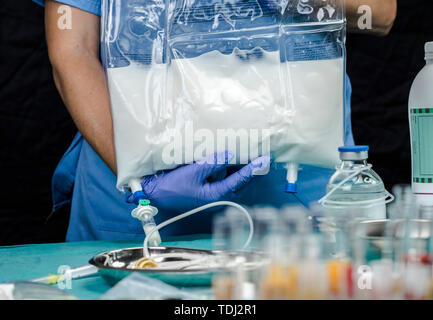 Nurse preparing medication for parenteral nutrition in a hospital, conceptual image Stock Photo