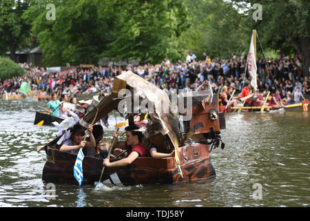 Cambridge University students in boats made from cardboard float down the River Cam in Cambridge on the Suicide Sunday, part of the annual traditions to celebrate the end of exams. Stock Photo